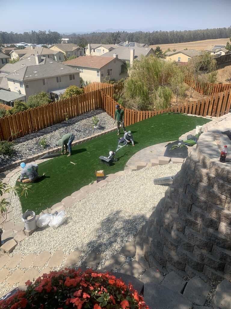 Hillside artificial turf and paver installation