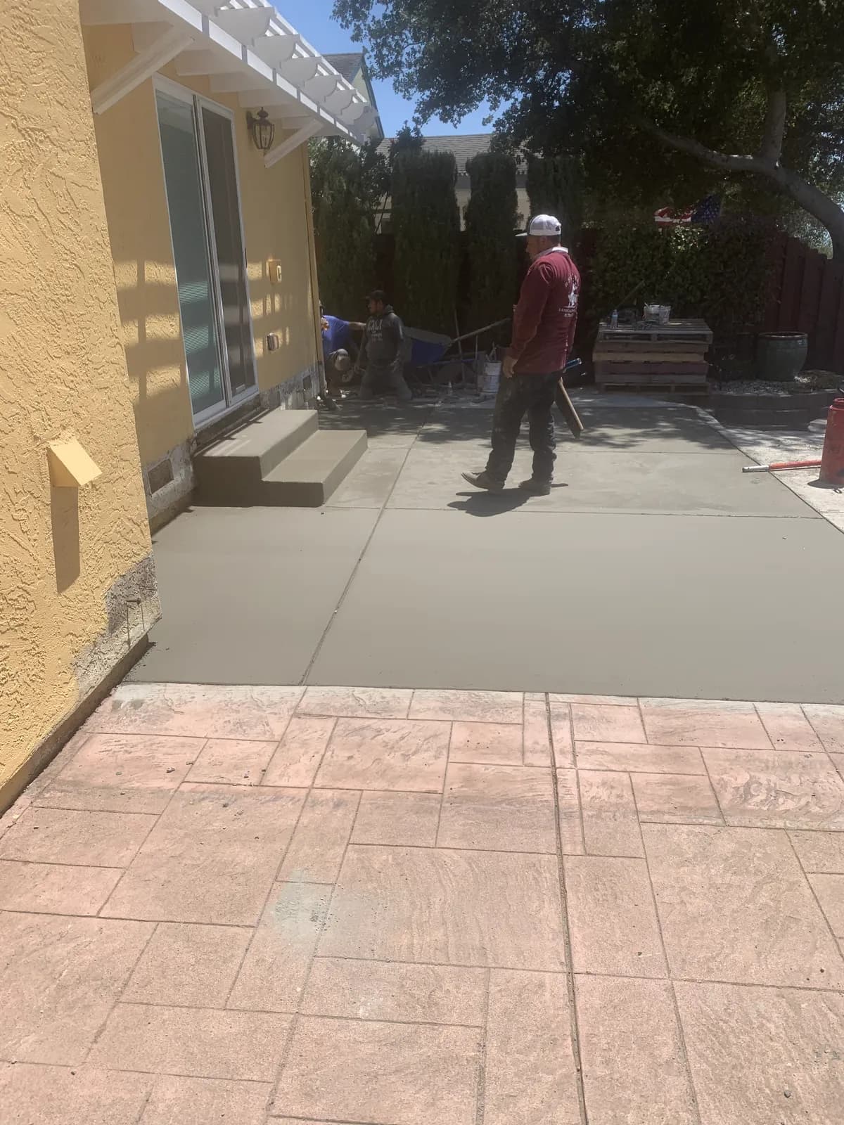 Finished stamped concrete patio adjoining a new turf lawn