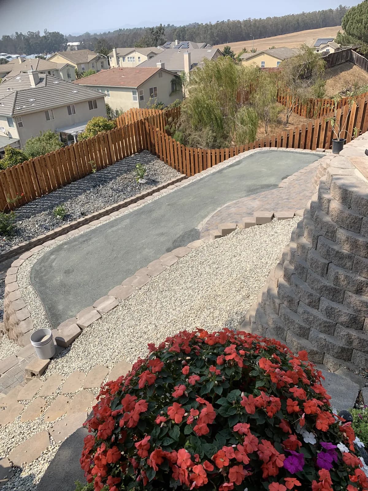 Finished putting green bordered by gravel and flowering colour