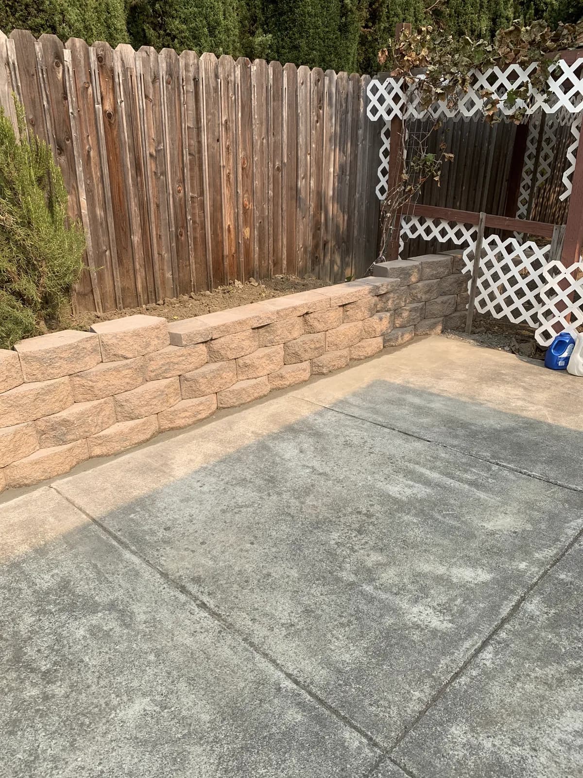 Completed block retaining wall along a side yard