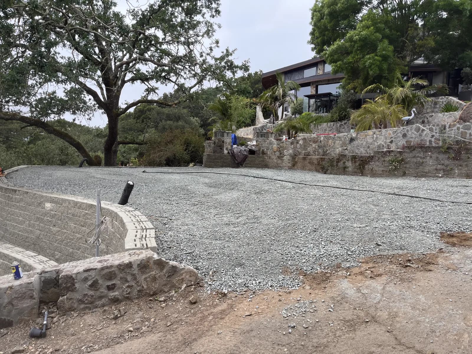 Finished stone retaining wall and gravel pad